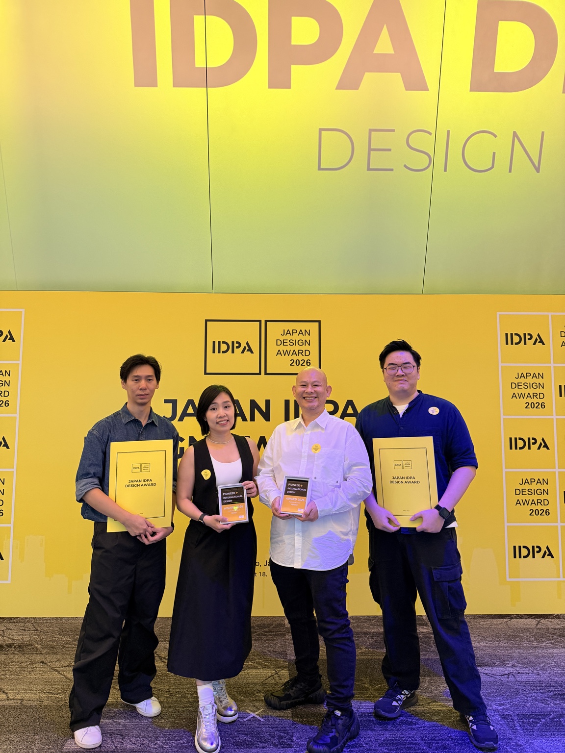DMZ team members celebrating at the Japan IDPA Design Award 2026 event.